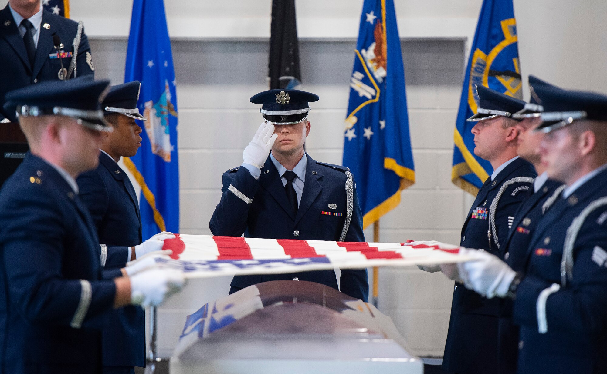 New members of the Wright-Patterson Air Force Base Honor Guard demonstrate a six-man flag-fold during their graduation ceremony, April 25, 2022. Guardsmen demonstrated the full funeral service, including gun salute and taps, prior to receiving their honor guard badges. (U.S. Air Force photo by R.J. Oriez)