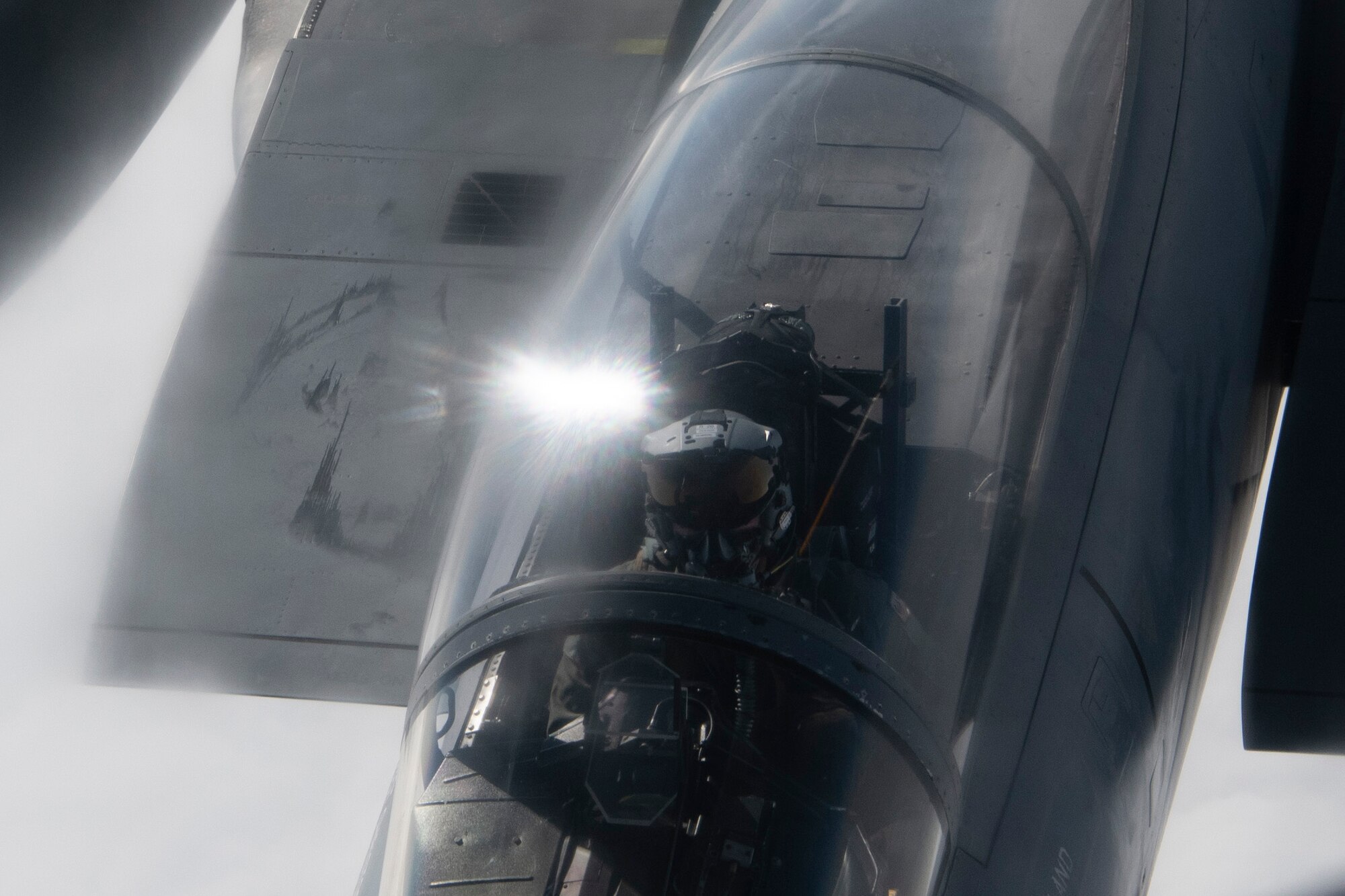 A photo of a fighter aircraft refueling while flying