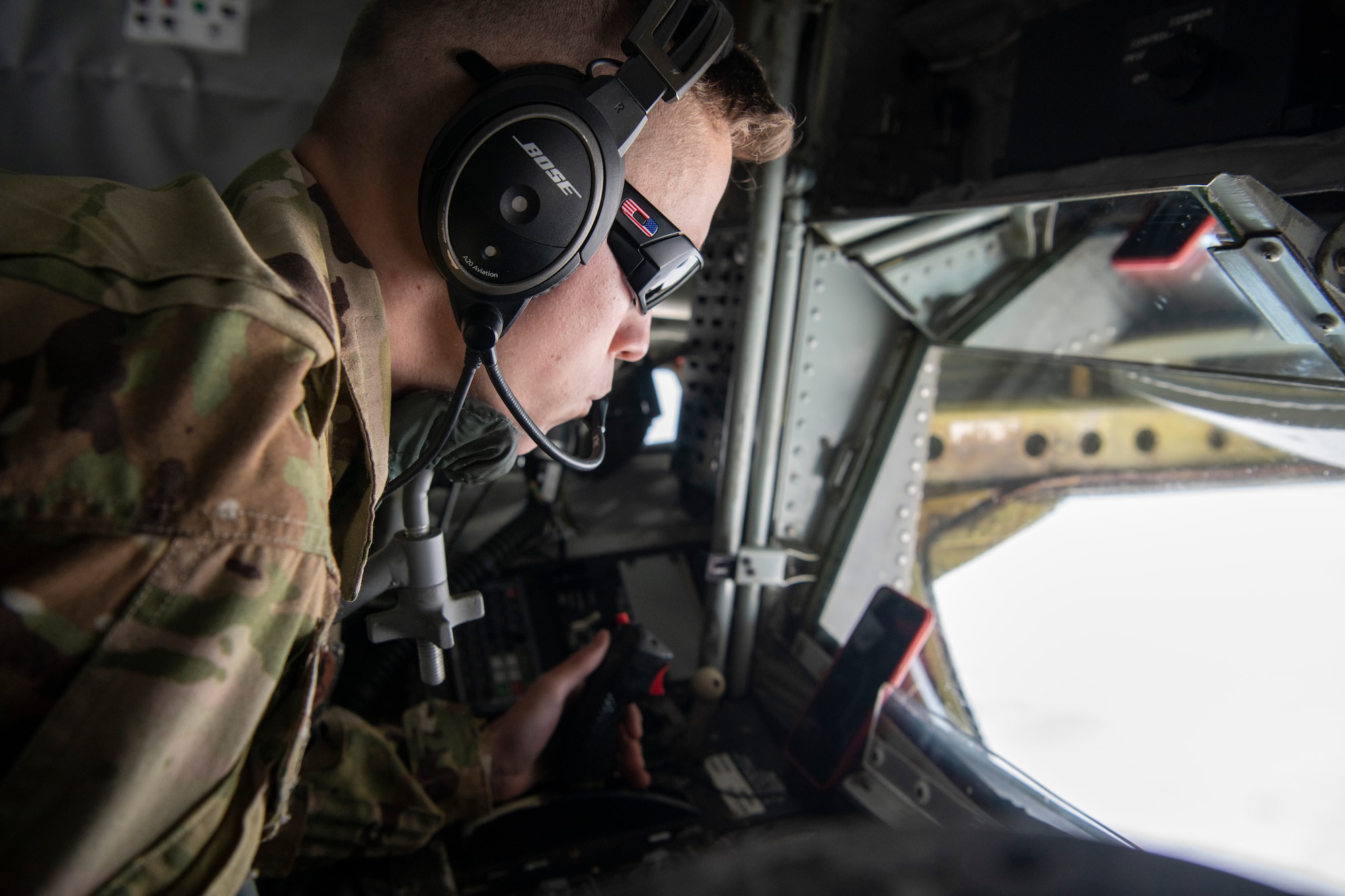 A photo of a fighter aircraft refueling while flying