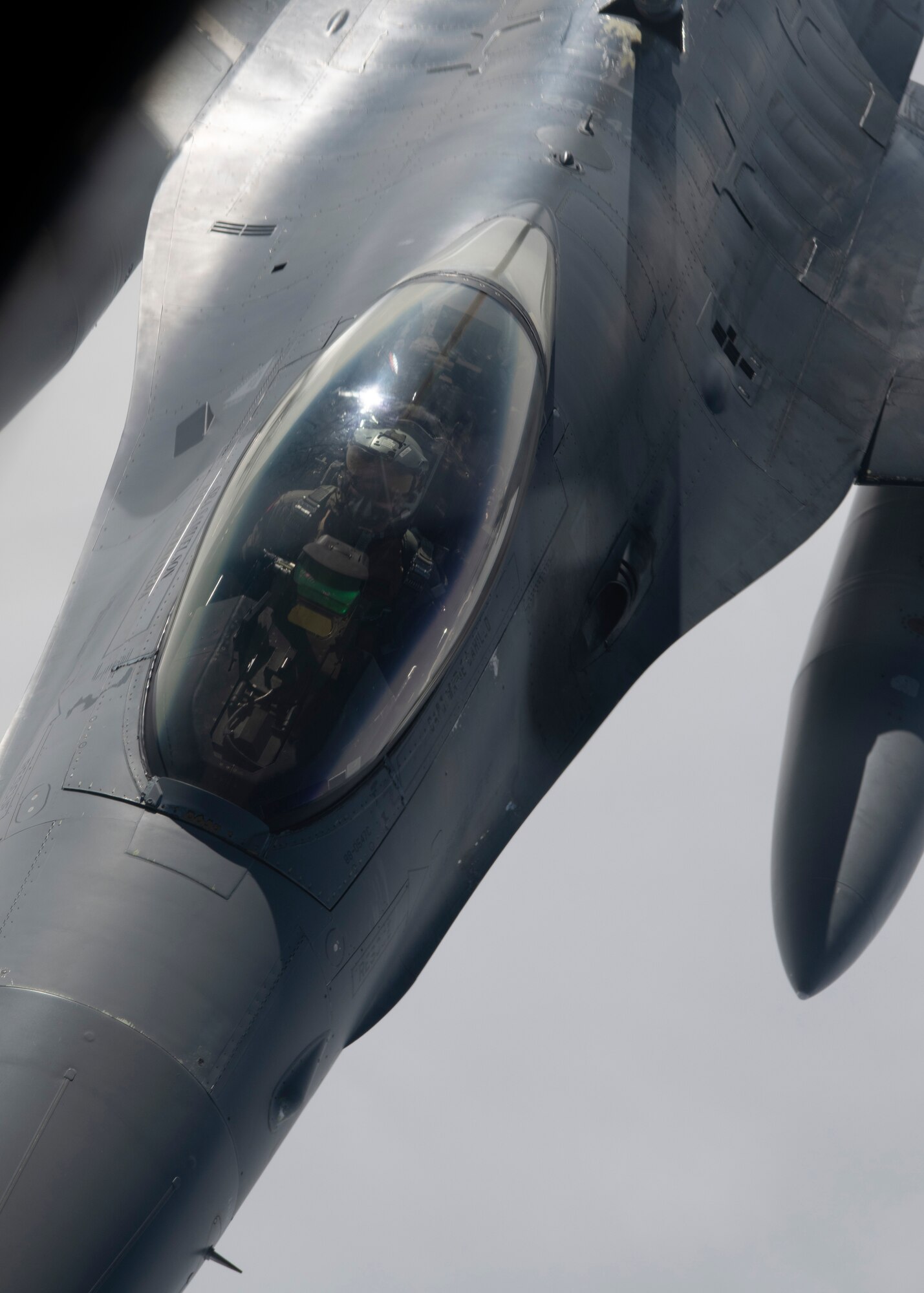 A photo of a fighter aircraft refueling while flying