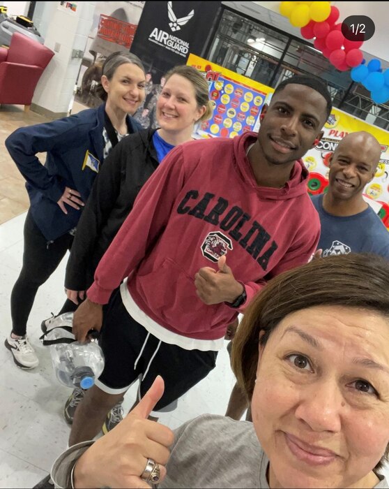 Photo shows a group of people posing for a selfie in fitness gear.