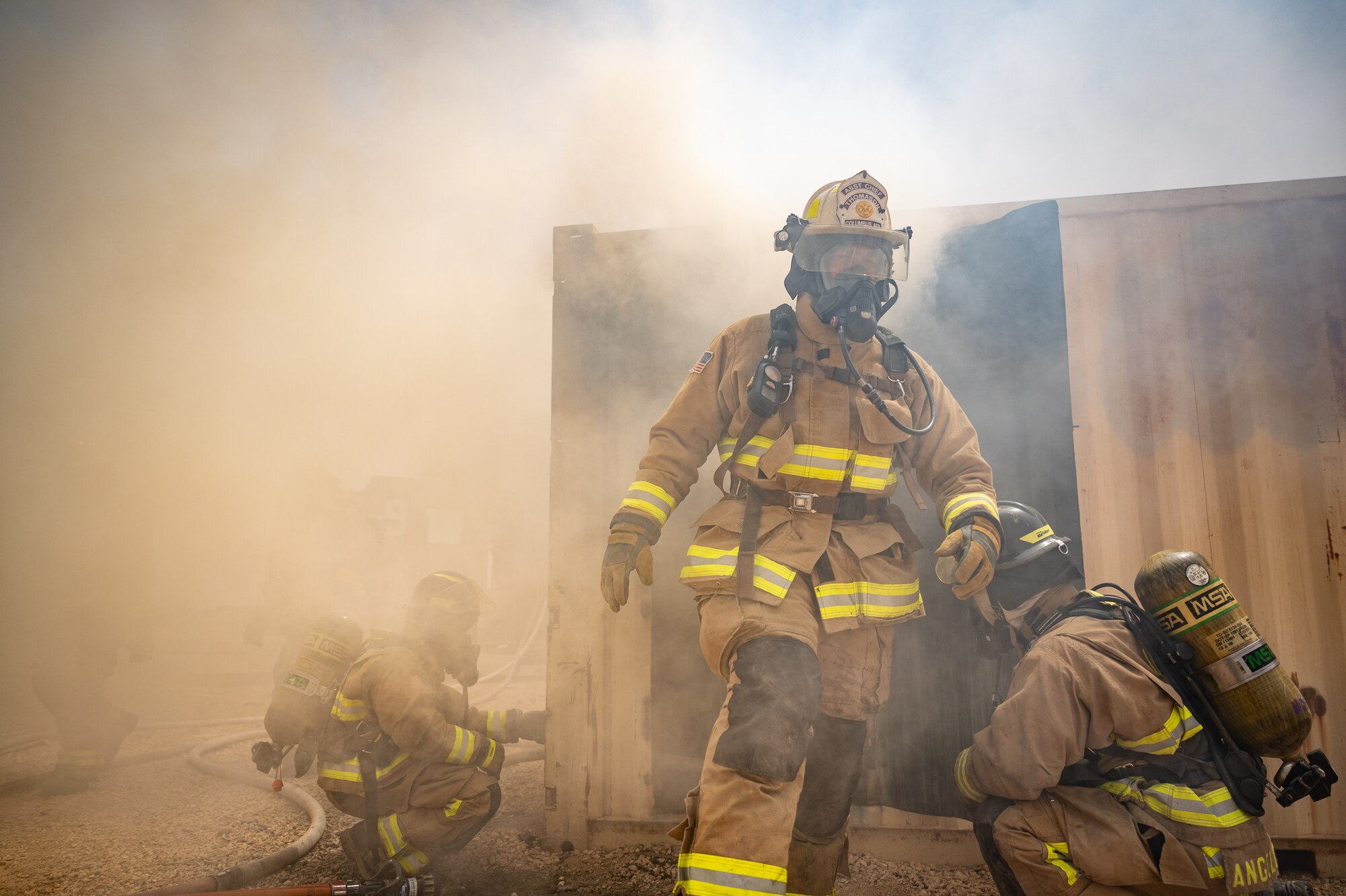 Lt. Col. Lee Turcottte, 332d Expeditionary Civil Engineer Squadron commander, walks away from an immediately dangerous to life or health area after egressing from the flashover trainer during live-fire flashover training at an undisclosed location in Southwest Asia, April 30, 2022. An immediately dangerous to life or health area is an atmospheric concentration of any toxic, corrosive or asphyxiant substance that poses an immediate threat to life or would cause irreversible or delayed adverse health effects. (U.S. Air Force photo by Master Sgt. Christopher Parr)