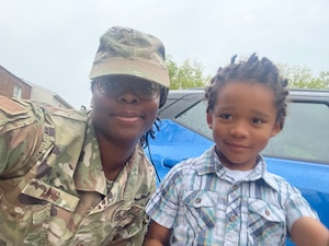 Master Sgt. Thersha Lewis, 459th Force Support Squadron, Transition Assistance Program counselor, poses for a photo with her son, Jasiri Amari Lewis, 5, while at home relaxing. Lewis plans to celebrate Mother’s Day with her son as well as take some time for self-care. (Courtesy Photo)