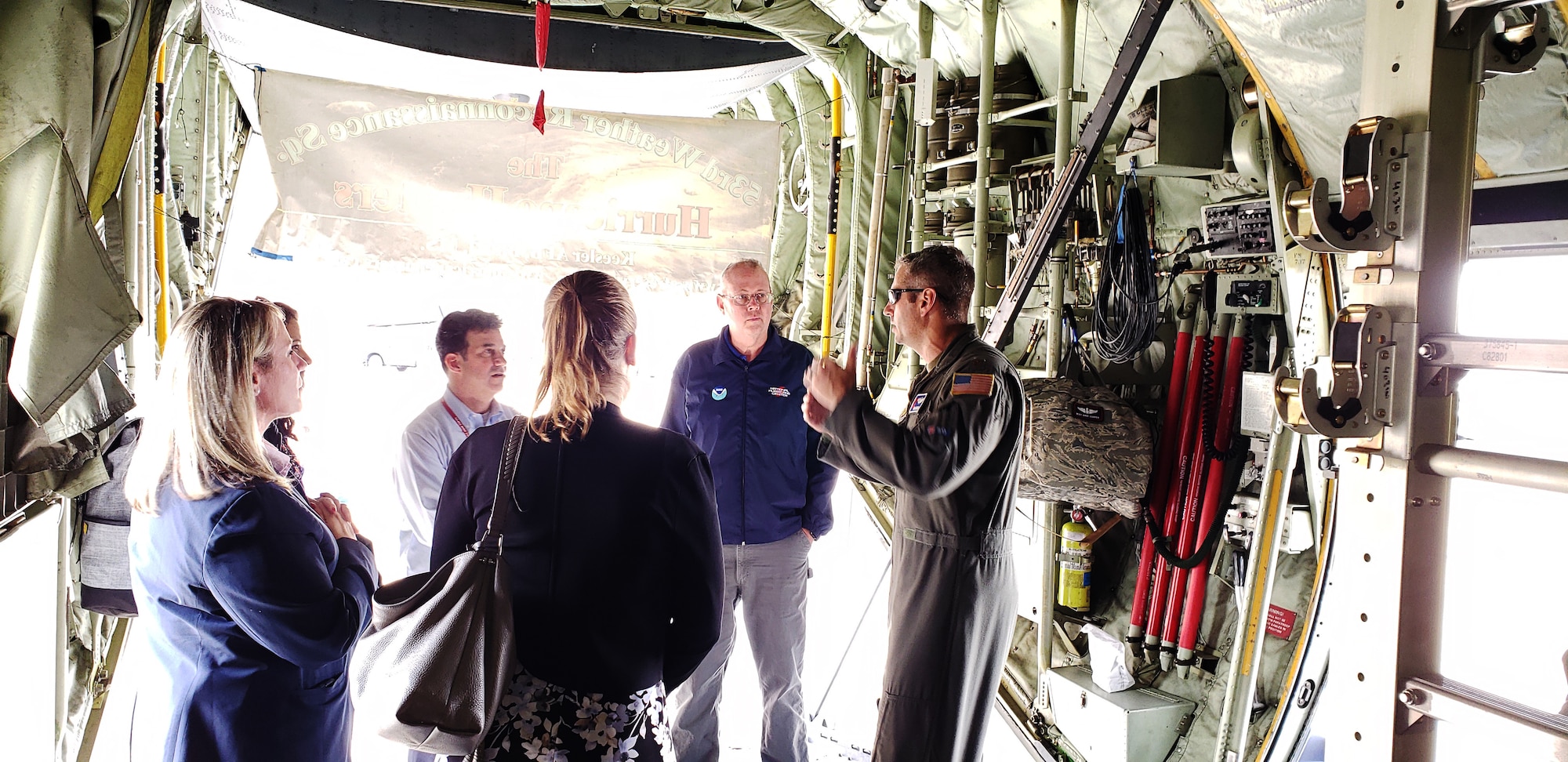 Air Force Reserve pilot briefs members about mission in the back of a WC-130J Super Hercules.