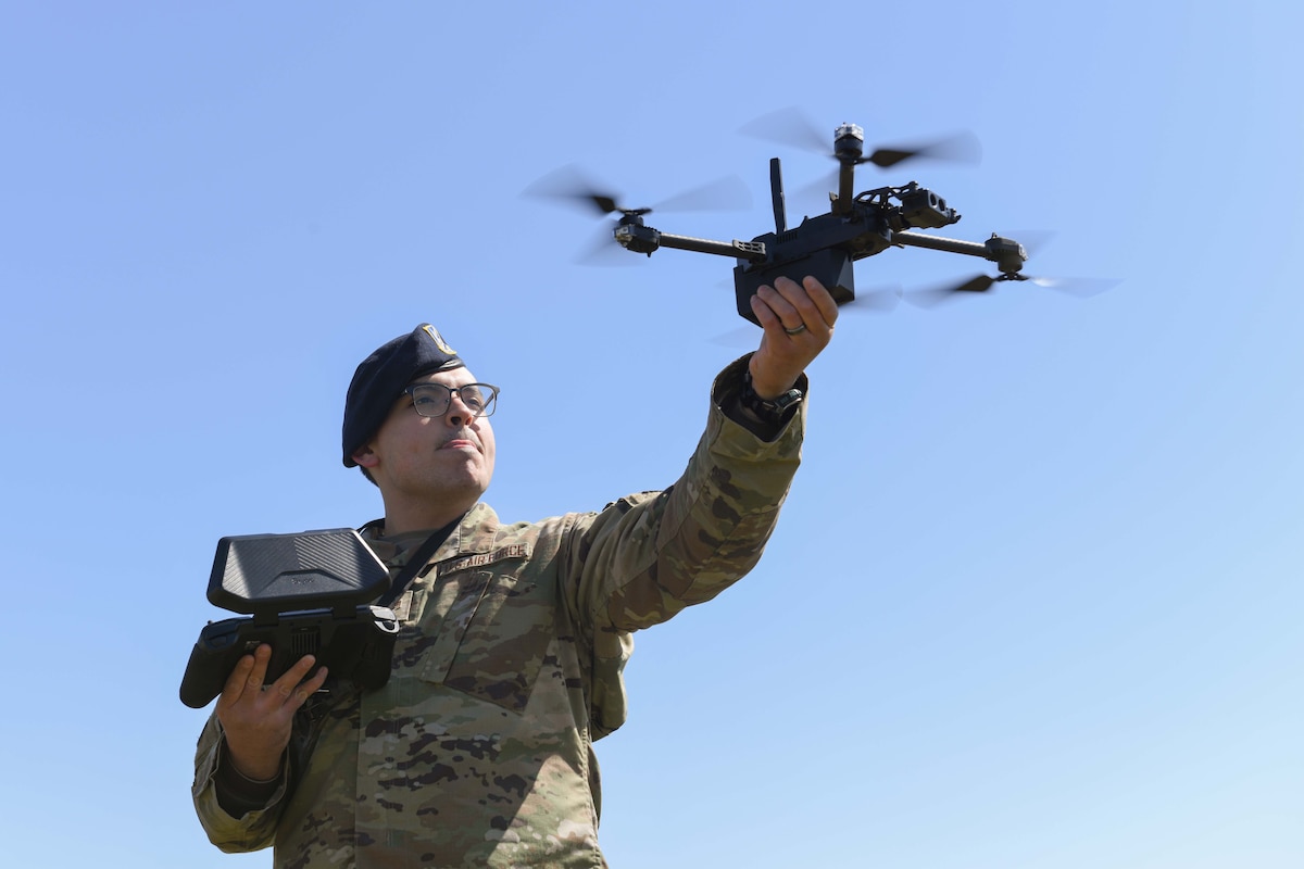 Senior Airman Roberto Bravo, 319th Security Forces Squadron installation entry controller, catches a landing drone during an unmanned aircraft system flight training course at the University of North Dakota, Grand Forks, North Dakota, April 27, 2022. The drones can be operated at ground level getting up close to dangerous situations to get eyes on the scene without putting members at risk. (U.S. Air Force photo by Senior Airman Ashley Richards)