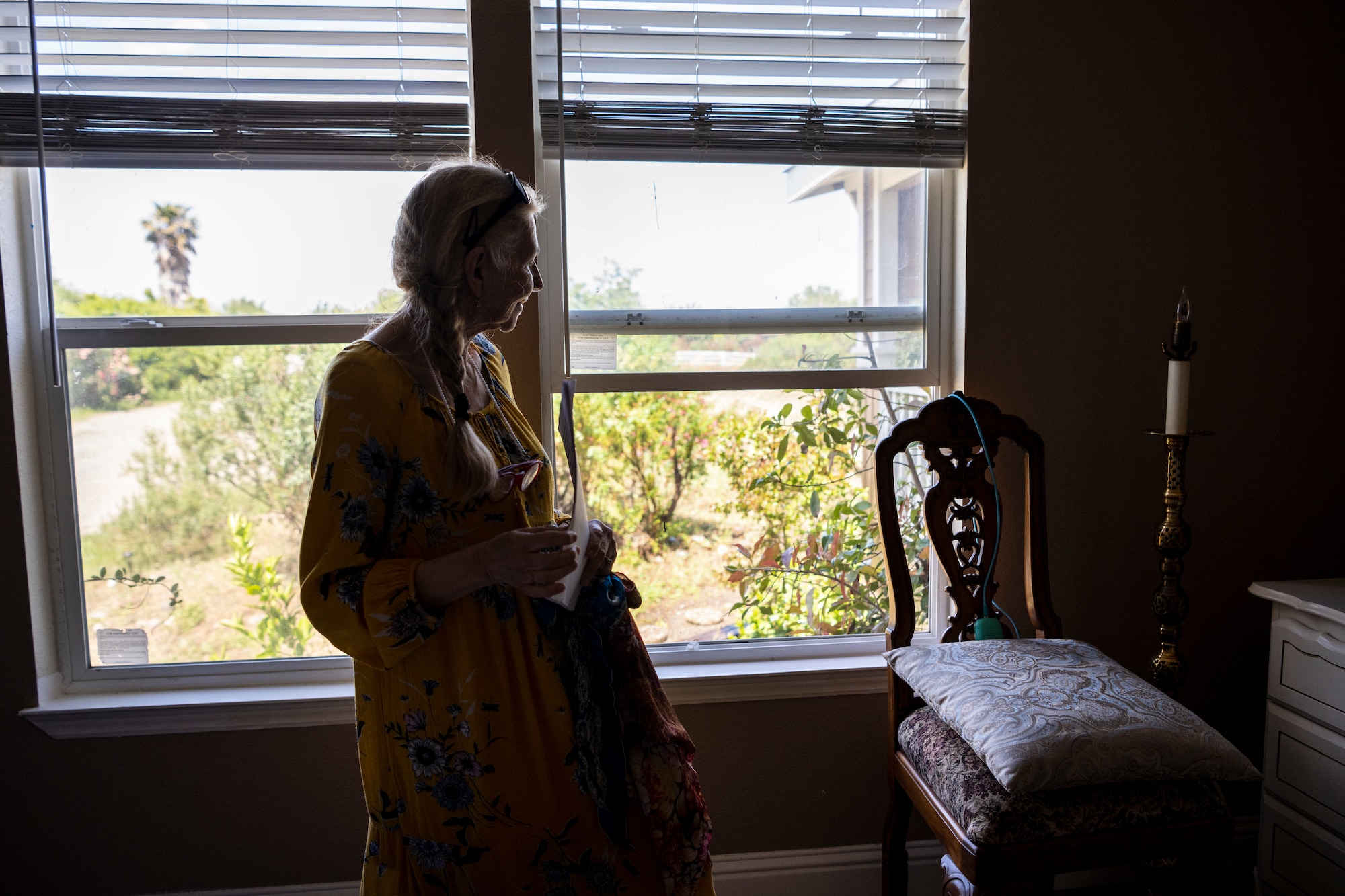 A woman standing in her room.