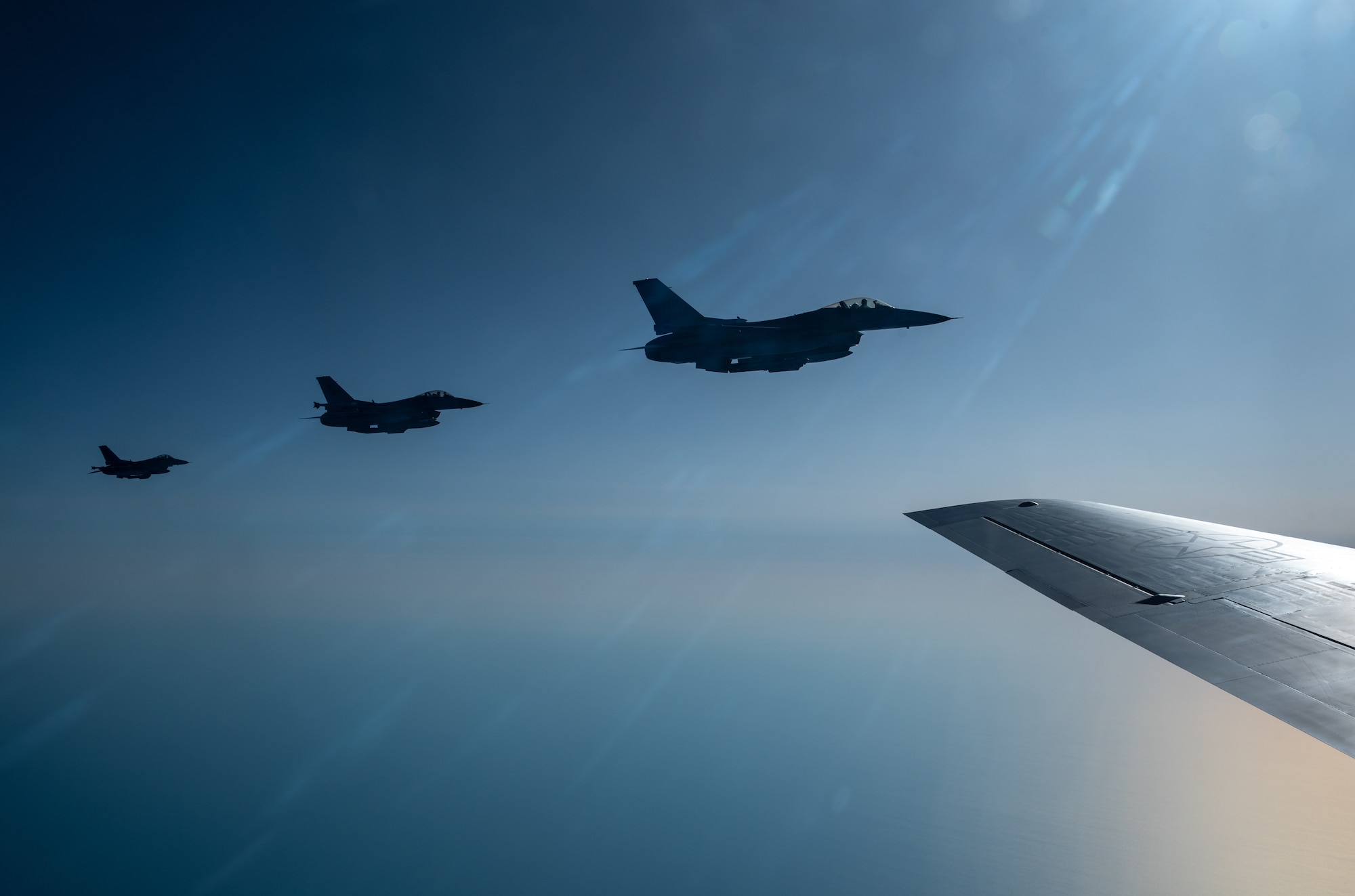 Three aircraft fly alongside an aircraft