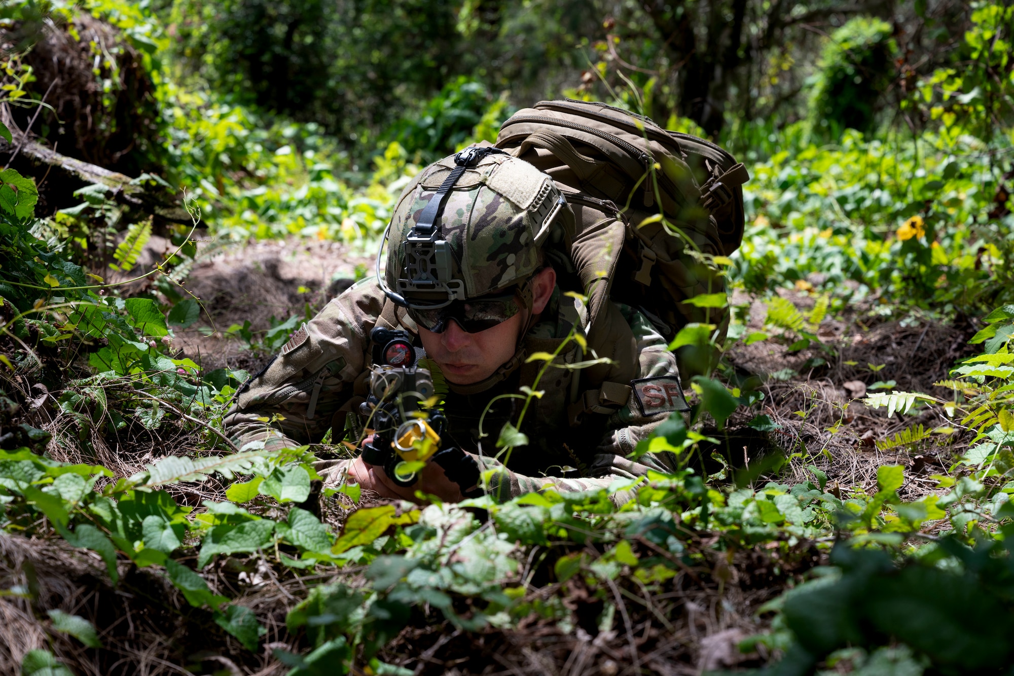 A U.S. Air Force Airman with the 736th Security Forces Squadron lays in the prone position during a combat training course at Andersen Air Force Base, Guam, May 3, 2022.