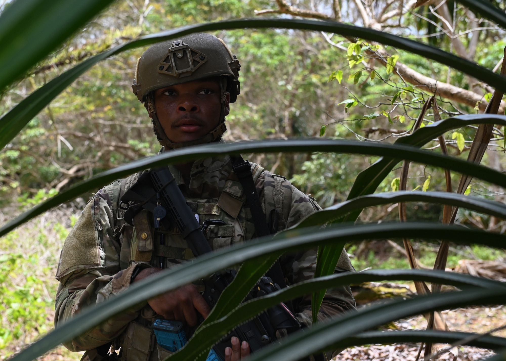 A U.S. Air Force Airman with the 736th Security Forces Squadron stays alert after two stimulated explosions during a combat training course at Andersen Air Force Base, Guam, May 3, 2022.