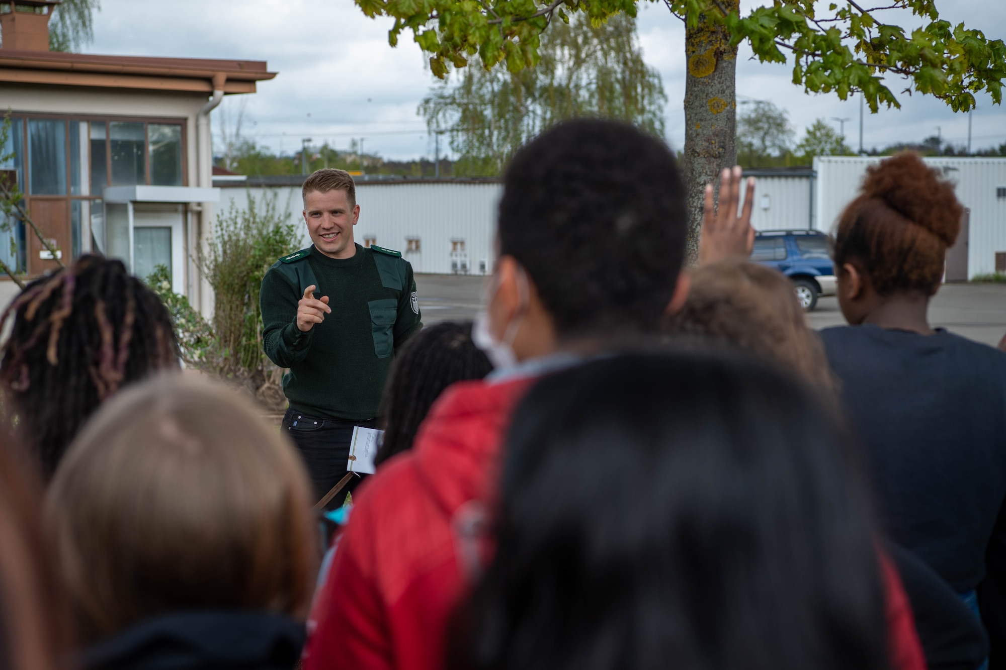 Lukas Schaefer, German Federal Forest Department local forstmeister, speaks to fifth graders from Kaiserslautern Elementary School at a tree planting event, at Vogelweh Military Complex, Germany, April 26, 2022. Schaefer discussed the importance of trees and how humans can give back to Earth by taking care of them. (U.S. Air Force photo by Airman 1st Class Jordan Lazaro)