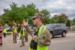 Pfc. Steven Hensen of the 223rd Military Police Company directs traffic and pedestrians at the 148th Kentucky Derby at Churchill Downs, Louisville, KY, May 7, 2022.