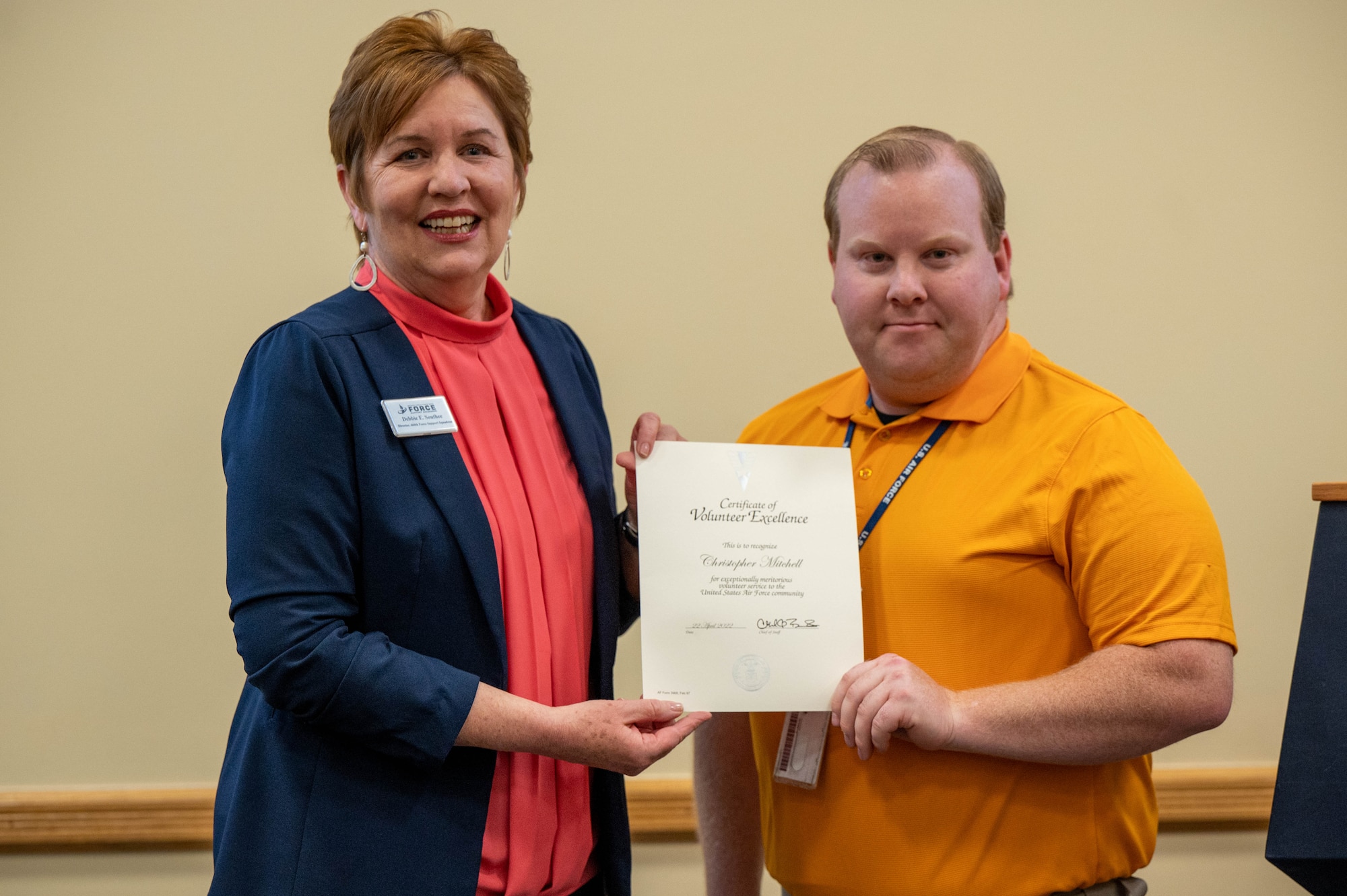 Christopher Mitchell, Key Spouse for 460 Force Support squadron and the 460th LRS, receives the Volunteer Excellence award, presented by Mrs. Debbie South, Director of the 460th Force Support Squadron  at Buckley Space Force Base, Colo., April 22, 2022.