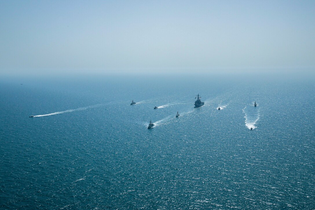 ARABIAN GULF (April 7, 2021) – Royal Bahrain Naval Force fast attack craft RBNS Abdul Rahman Al-fadel (P 22), Bahrain Coast Guard response boats Hawar 5 and Hawar 4, U.S. Navy guided-missile destroyer USS Mahan (DDG 72), patrol coastal ships USS Squall (PC 7) and USS Hurricane (PC 3), U.S. Coast Guard patrol boat USCGC Adak (WBP 1333) and two Mark VI patrol boats operate in formation during exercise Neon Defender in the Arabian Gulf, April 7. Neon Defender 21 is a bilateral maritime exercise between the U.S. and Bahrain, designed to enhance interoperability and readiness, fortify military-to-military relationships and advance operational capabilities, allowing participating naval forces to effectively develop the necessary skills to address threats to regional security, freedom of navigation and the free flow of commerce. (Army Photo by Spc. Evens Milcette Jr.)