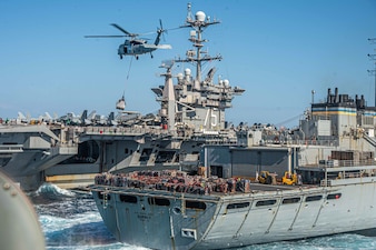 USS Harry S. Truman (CVN 75) replenishes from USNS Supply (T-AOE 6) in the Ionian Sea.