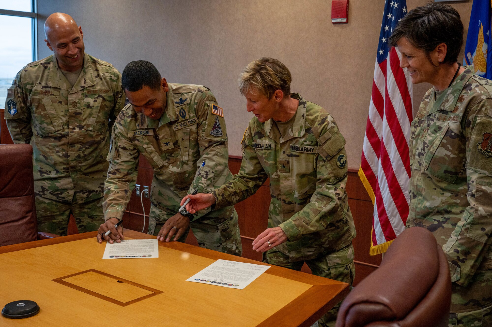 From left to right, U.S. Air Force Chief Master Sgt. Robert Devall, Buckley Garrison command chief, U.S. Space Force Col. Marcus Jackson, Buckley Garrison commander, U.S. Army Brig. Gen. Laura Clellan, Adjutant General, and U.S. Air Force Chief Master Sgt. Lisa Perry, 140th Wing command chief, sign the Sexual Assault and Awareness Prevention Proclamation at Buckley Space Force Base, Colo., March 29, 2022.