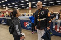 U.S. Marine Corps Gunnery Sgt. Justin. M. Boling,  the Marine Corps Recruiting Command Marketing and Communications Chief, speaks with  Clarissa Chun, the University of Iowa's Women's Wrestling Coach during the USAW Women's National  at Fort Worth, Texas on May 07, 2022.  The Marine Corps began partnering with USAW in 2017 to share career opportunities, leadership and celebrate the spirit of competition while offering opportunities to athletes and coaches involved with the sport of wrestling. By partnering specifically with USAW, the Marine Corps reaches a broad cross-section of high school and collegiate-aged wrestlers as well as an ever-growing influencer network of coaches, referees, wrestling alumni, and parents. (U.S. Marine Corps photo by Lance Cpl. Gustavo Romero)