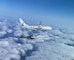 A P-8 Poseidon and an EA-18G Growler fly in formation.