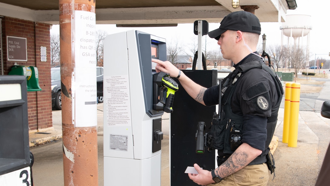 a man in uniform operates the Electronic Point of Sale system