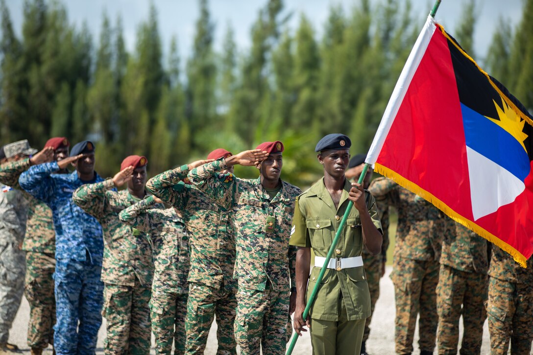 Service members and distinguished visitors from various nations participate in the Opening Ceremony at Price Barracks for Exercise Tradewinds 2022, May, 7 2022.