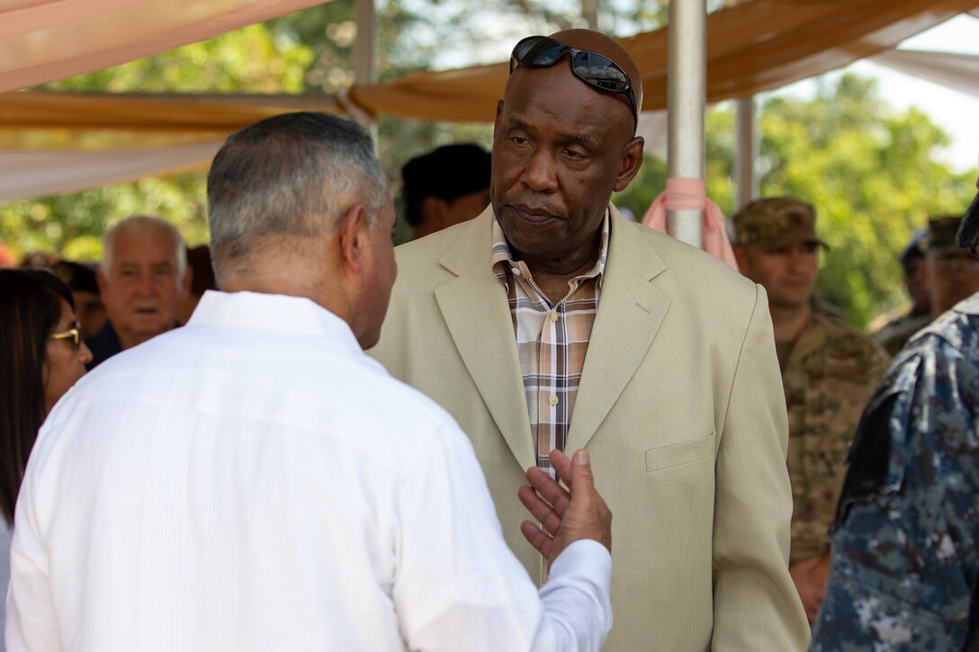 The Prime Minster of Belize, John Briceno speaks with Mr. Kevin Bostick, Director of South Command Exercises and Coalition Affairs at the Opening Ceremony at Price Barracks for Exercise Tradewinds 2022, May, 7 2022.