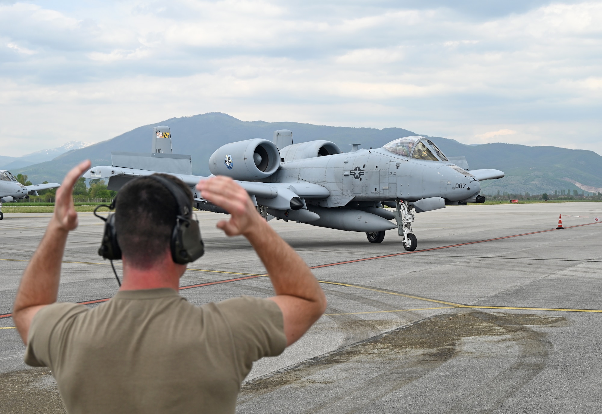 U.S. Air Force Staff Sgt. Dylan Martin, crew chief assigned to the 175th Aircraft Maintenance Squadron, guides an A-10C Thunderbolt II aircraft assigned to the 104th Fighter Squadron, Maryland Air National Guard, after arriving at Ohrid St. Paul The Apostle Airport in Ohrid, North Macedonia, May 7, 2022, ready to conduct Agile Combat Employment training in support of the Swift Response exercise. Exercise Swift Response 22 is an annual multinational training exercise, which takes place in Eastern Europe, the Arctic High North, Baltics, and Balkans from May 2-20, 2022. The purpose of the exercise is to present combat credible Army forces in Europe and Africa, and enhance readiness by building airborne interoperability with Allies and Partners and the integration of joint service partnership. (U.S. Air National Guard photo by Master Sgt. Christopher Schepers)