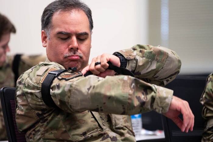 Airman applies tourniquet