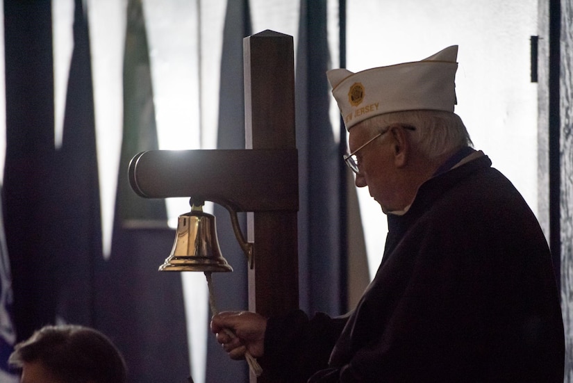 A U.S. service member veteran rings a bell