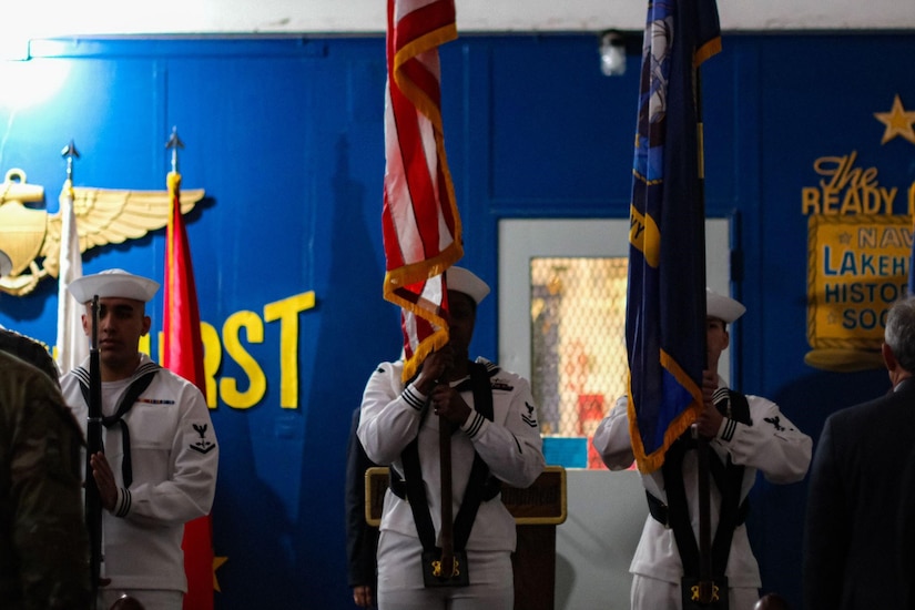 U.S. Navy Honor Guard holds flags