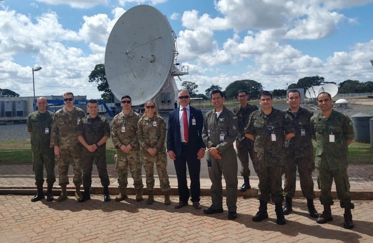 New York Air National Guard Airmen from the 222nd Command and Control Squadron, which augments the U.S. agency managing American surveillance satellites, pose with Brazilian officials at Brazil’s Space Operations Center in Brasilia, the country’s capital on April 19, 2022.