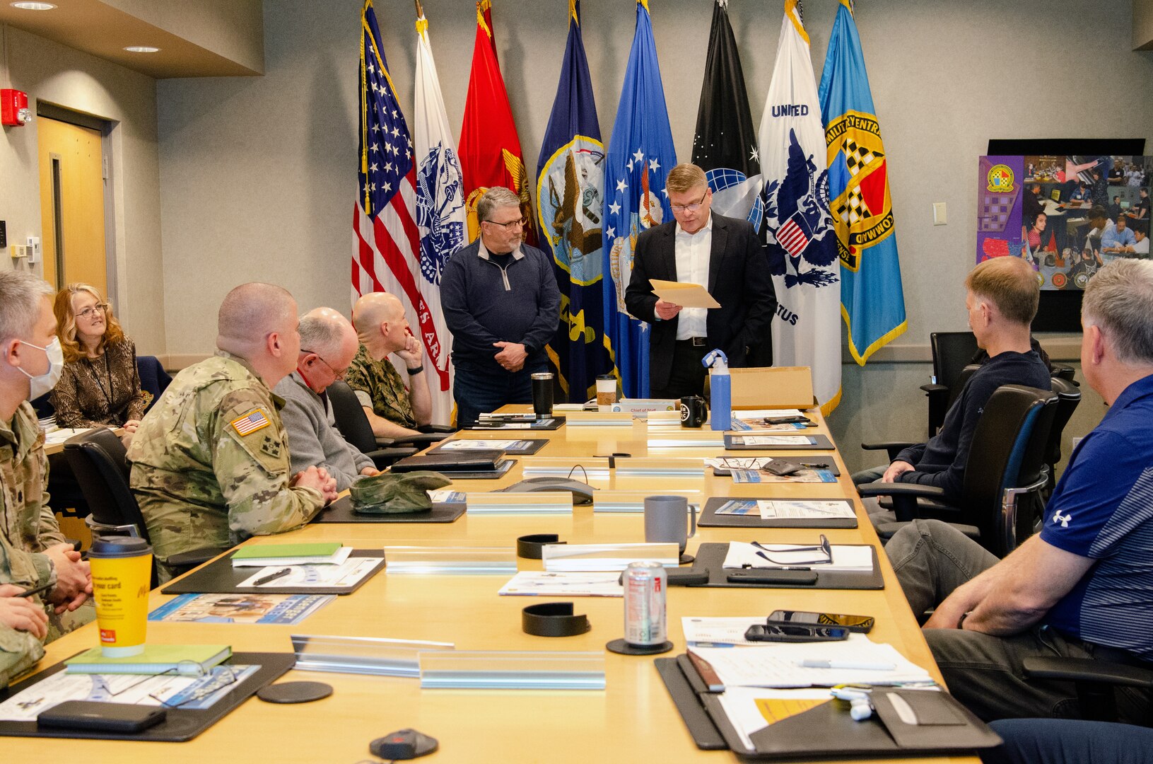 Donovan Phillips, USMEPCOM Chief of Staff, (right) reads the citation for an honorary Hamby award presented to David Hamby, USMEPCOM inspector general (left) during a command and staff meeting, May 6. The Hamby award, usually presented to Soldiers at Fort Irwin, was created in memory of the late U.S. Army Col. Jerrell Hamby, David’s father.