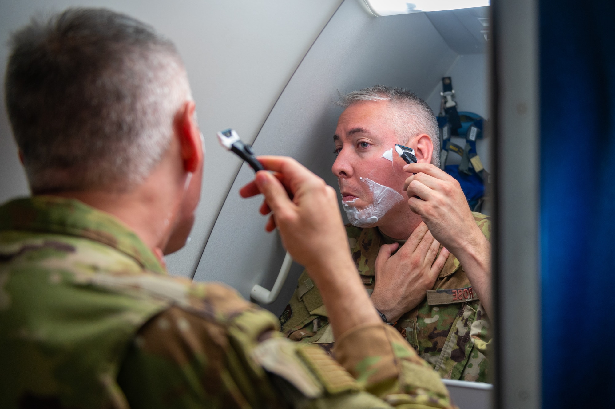Major Kevin Rose, 349th Air Refueling Squadron instructor pilot, shaves his face May 6, 2022. Rose was one of six pilots aboard the 24-hour sortie out of McConnell Air Force Base, Kansas, which was the longest flight in Air Mobility Command’s history. (U.S. Air Force photo by Airman Brenden Beezley)
