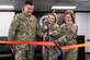Col. Kirsten Aguilar cuts the ceremonial ribbon with Col. Roger McIllece and Lt. Col. Sandy Caruco
