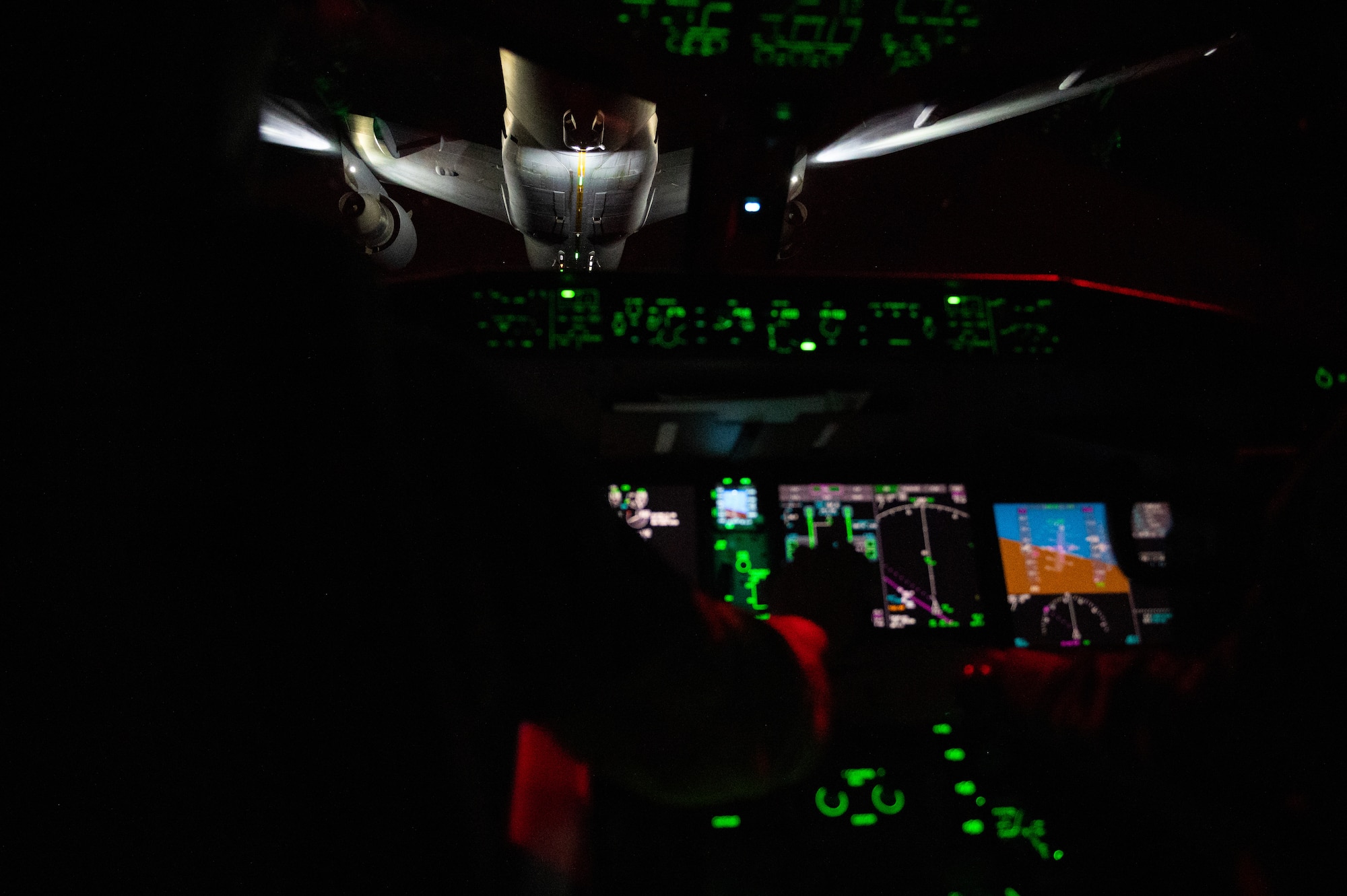 Major Kevin Rose, 349th Air Refueling Squadron instructor pilot, and Capt. Kevin Abbott, 344th Air Refueling Squadron instructor pilot, pilot a KC-46A Pegasus while receiving fuel from another KC-46 stationed at McConnell Air Force Base, Kansas, May 5, 2022. The crew were flying a 24-hour sortie, the longest in Air Mobility Command’s history. In order to ensure the safety of the flight, two pilot crews rotated on and off four-hour shifts allowing adequate time for rest. (U.S. Air Force photo by Airman Brenden Beezley)