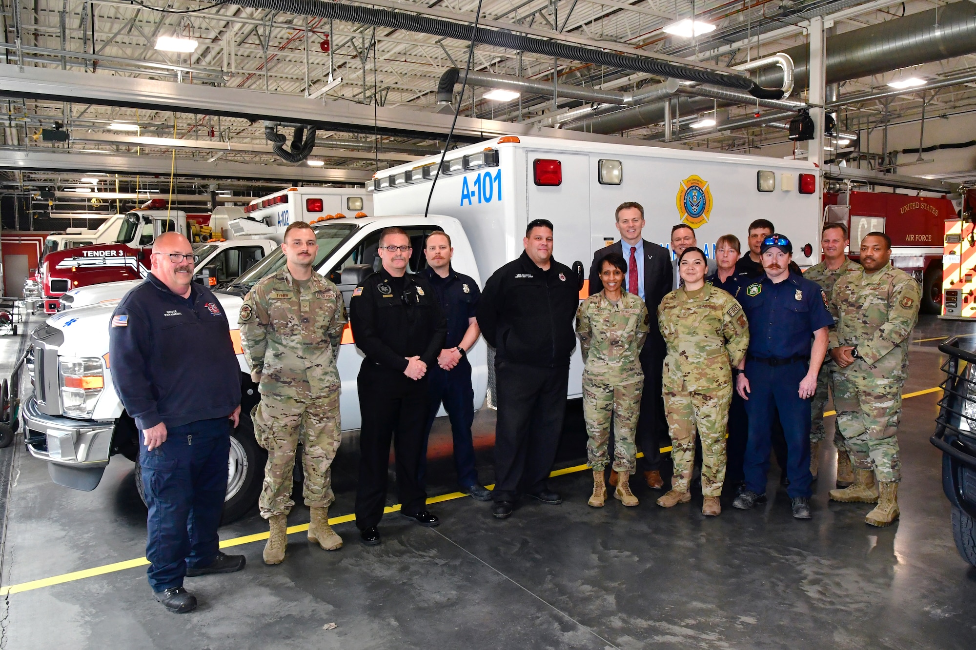 Col. Jenise Carroll, 75th Air Base Wing commander, and U.S. Rep. Blake Moore (UT-1) pose for a group photo with fire personnel.