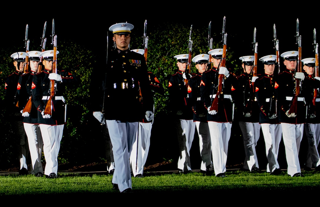 Marines with the Silent Drill Platoon perform during a Friday Evening Parade at Marine Barracks Washington, April 29, 2022. The guest of honor for the evening was Gen. David H. Berger, the 38th Commandant of the Marine Corps, and the hosting official was Col. Robert A. Sucher, the commanding officer of Marine Barracks Washington. (U.S. Marine Corps photo by Lance Cpl. Pranav Ramakrishna )