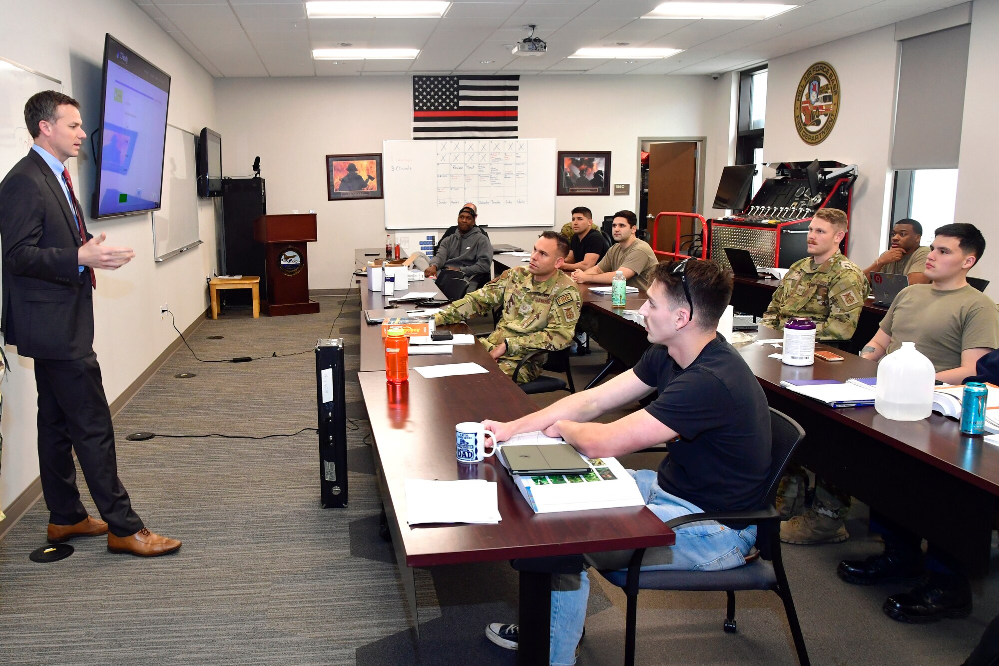 U.S. Rep. Blake Moore (UT-1) stands speaking  with fire personnel attending an advanced emergency medical technician course who are seated at tables.