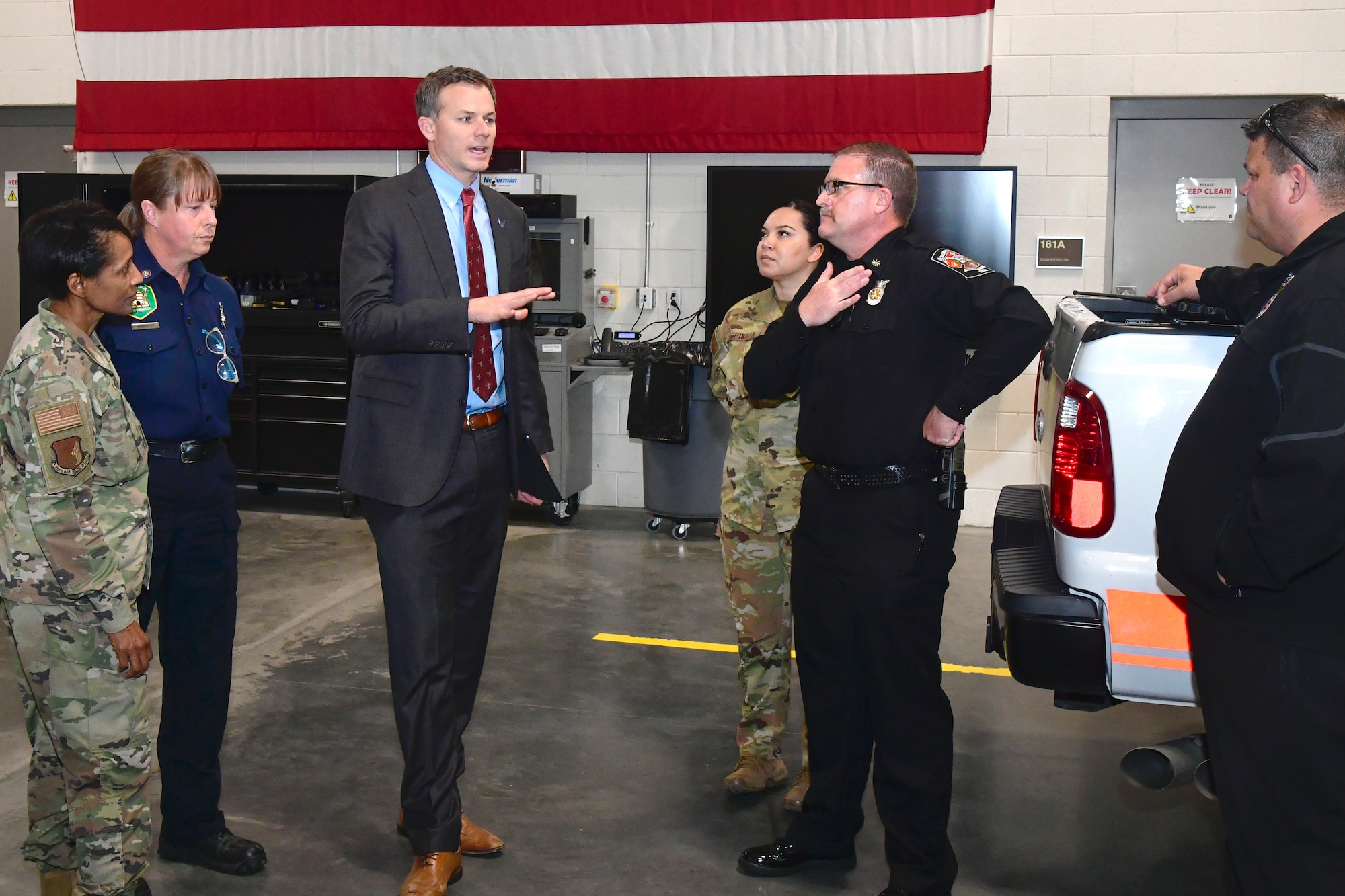 U.S. Rep. Blake Moore (UT-1) stands in the center of Hill AFB leadership and fire personnel.