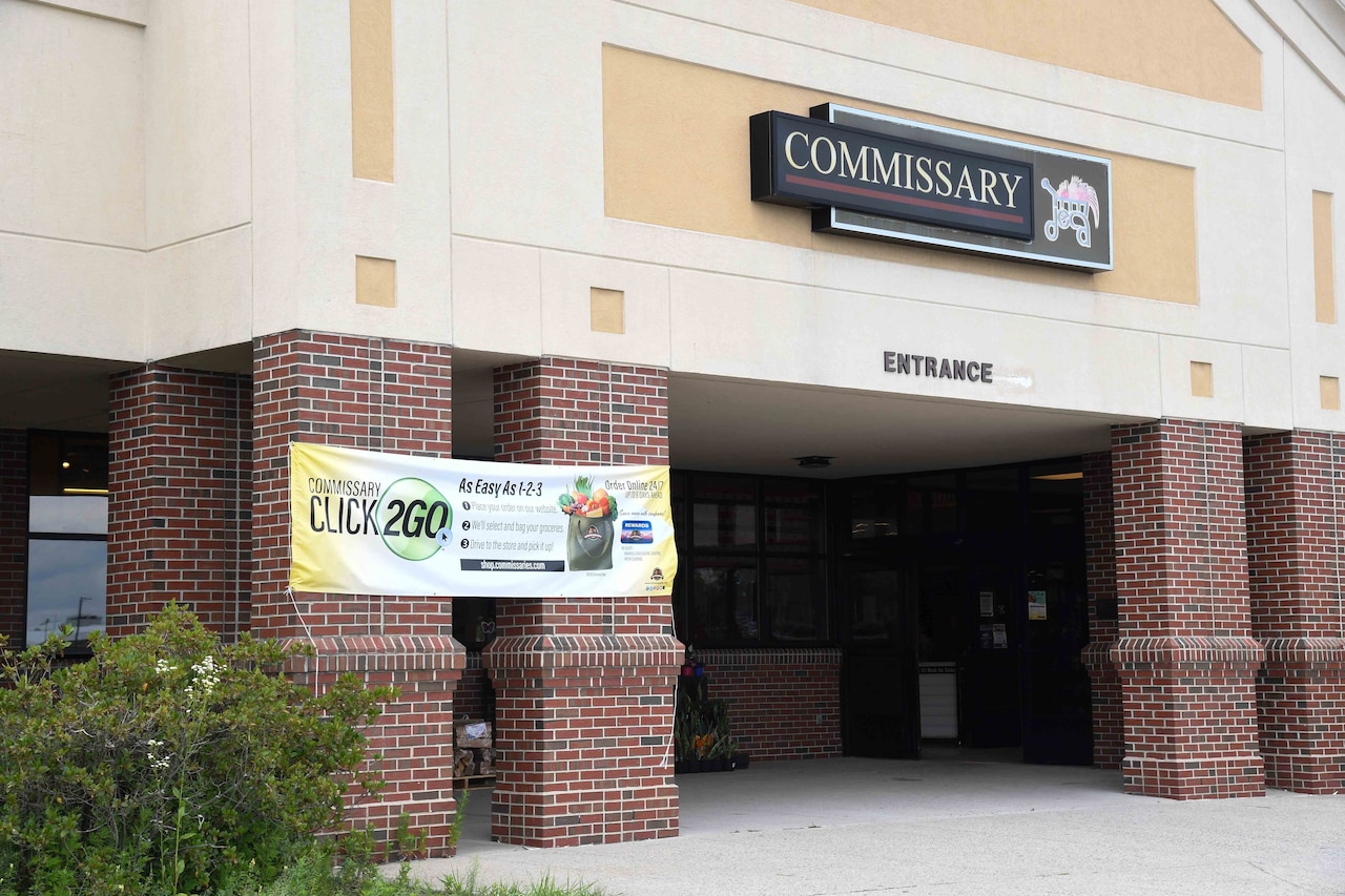 A sign above the entrance to a building reads “Commissary.”