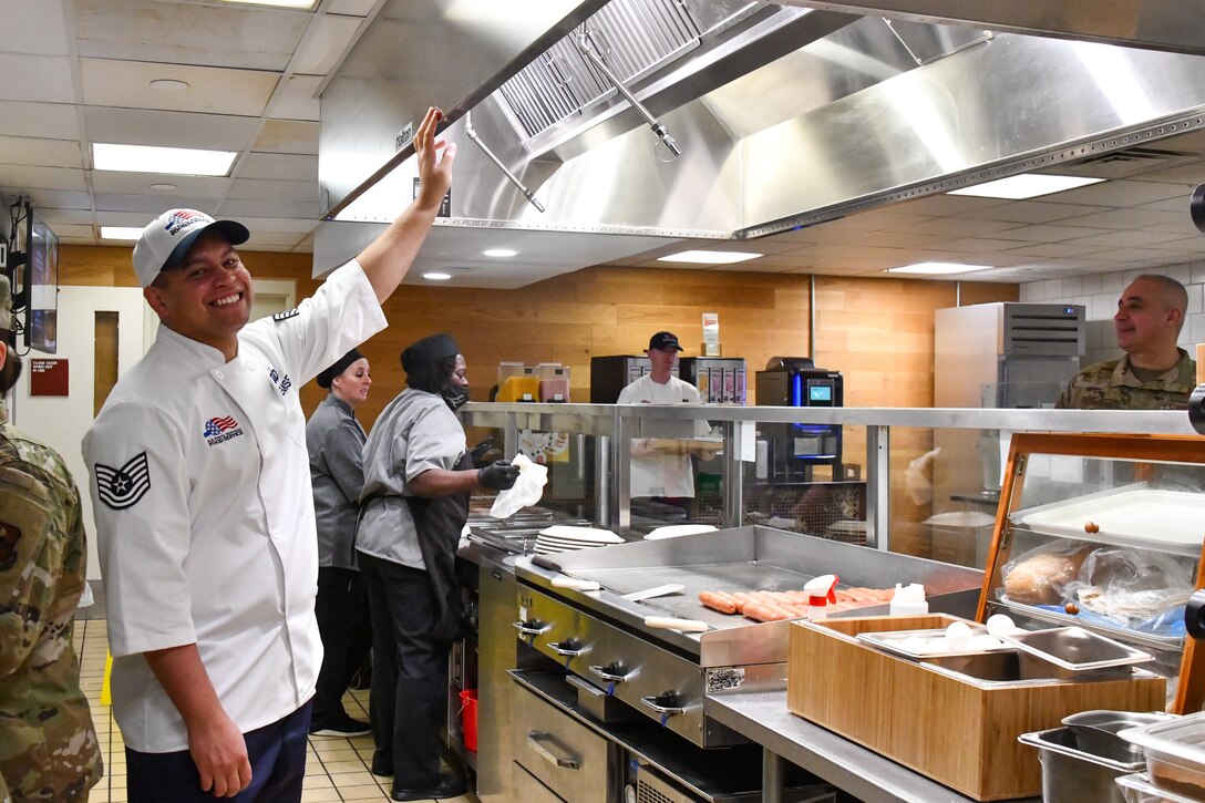 U.S. Air Force Tech. Sgt. William Proemsey, 97th Force Support Squadron dining facility manager, showcases a new ventilation system in the Hangar 97 dining facility at Altus Air Force Base, Oklahoma, April 28, 2022. The system features many new capabilities, including a sensor that alerts contractors immediately if the machine experiences any type of malfunction. (U.S. Air Force photo by Airman 1st Class Miyah Gray)