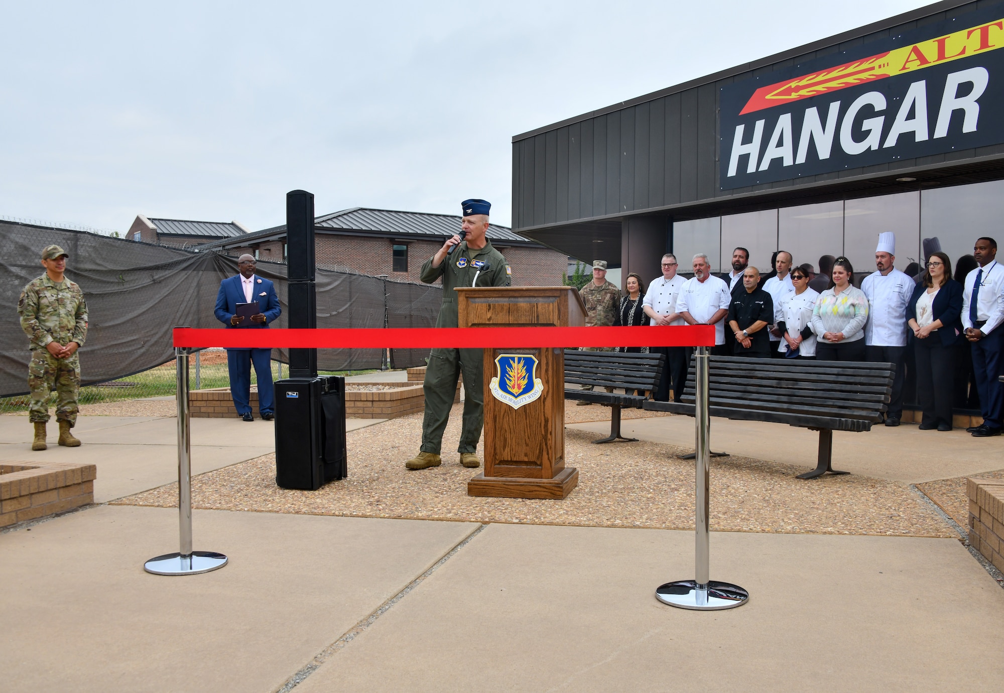 U.S. Air Force Col. Blaine Baker, 97th Air Mobility Wing commander, delivers a speech at the re-opening of Hangar 97 at Altus Air Force Base, Oklahoma, April 28, 2022. Baker spoke about the importance of a premier installation providing nutrition to Airmen. (U.S. Air Force photo by Airman 1st Class Miyah Gray)