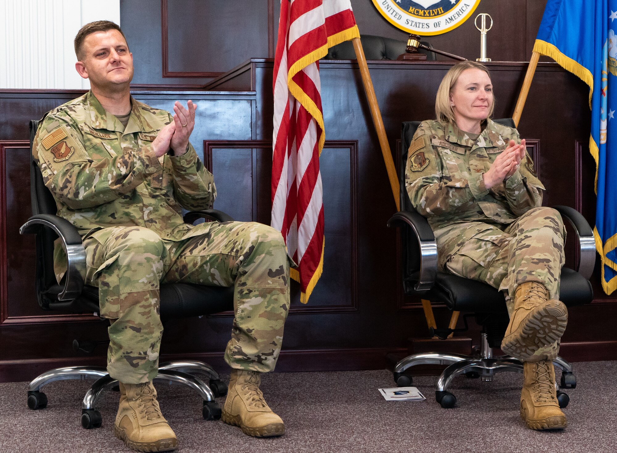 Col. Roger McIllece and  Col. Kirsten Aguilar clap during the ceremony