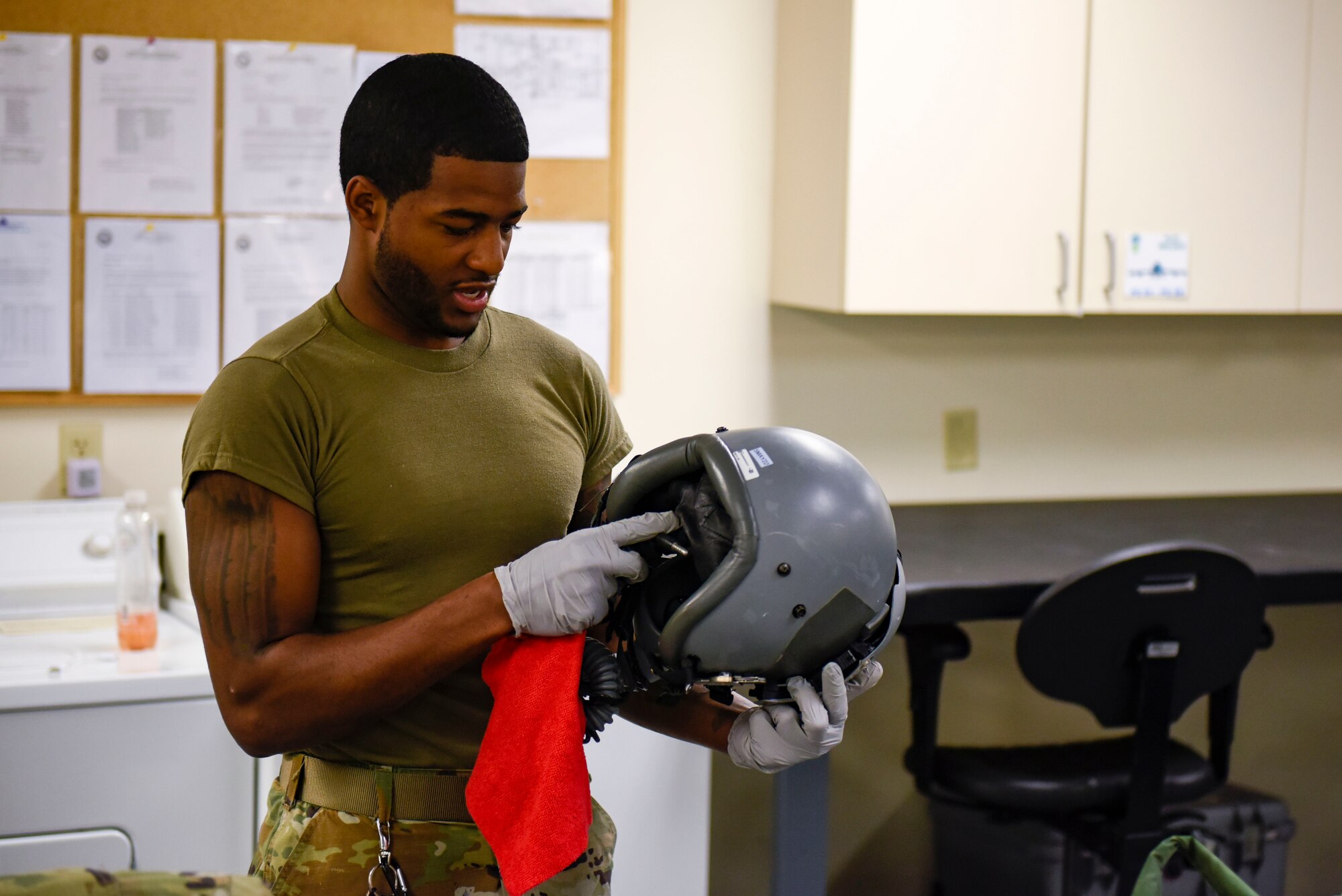 U.S. Air Force Staff Sgt. Aaron Smith, 92nd Operation Support Squadron Aircrew Flight Equipment craftsman, works on cleaning a pilot’s helmet on Fairchild Air Force Base, Washington, May 3, 2022. AFE’s job is to maintain the practicality and safety of equipment to prevent the unlikely event of defective gear. (U.S. Air Force photo by Airmen 1st Class Haiden Morris)