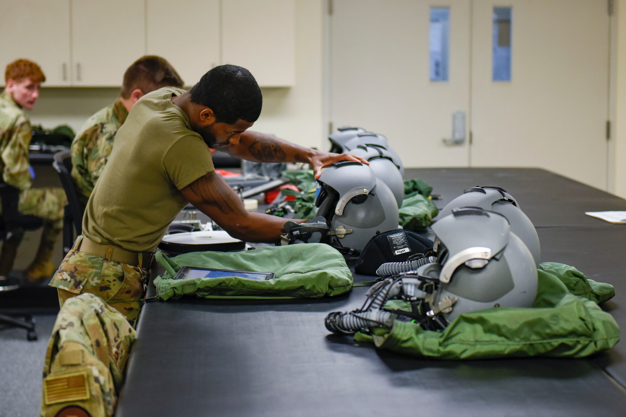 U.S. Air Force Staff  Sgt. Aaron Smith, 92nd Operation Support Squadron Aircrew Flight Equipment craftsman, disassembles a pilot’s helmet on Fairchild Air Force Base, Washington, May 3, 2022. AFE’s job is to maintain the practicality and safety of equipment to prevent the unlikely event of defective gear. (U.S. Air Force photo by Airmen 1st Class Haiden Morris)