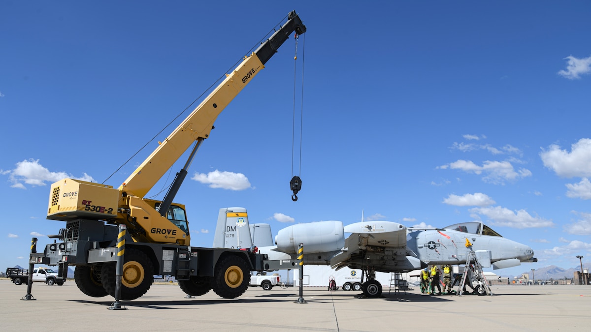 A photo of an aircraft and crane.