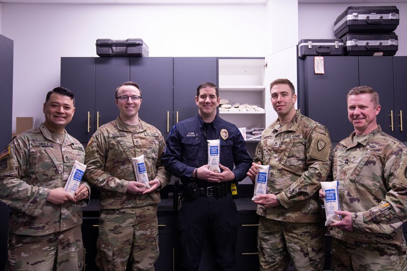 Alaska National Guardsmen assigned to the Counterdrug Support Unit and Sgt. Michael Lopez of the Wasilla Police Department display naloxone kits provided through Project HOPE in Wasilla, Alaska, April 13, 2022. The Alaska National Guard collaborates with the Office of Substance Misuse and Addiction Prevention in Project HOPE a state-run initiative aimed at providing opioid overdose rescue kits and training mission partners and law enforcement agencies. (Alaska National Guard photo by Victoria Granado)