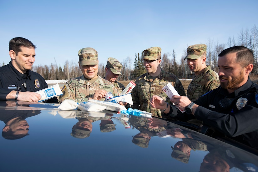 Alaska National Guardsmen Sgt. 1st Class Oliver Meza (second from left), noncommissioned officer in charge of Drug Demand Reduction, trains guardsmen and police officers in the use of naloxone kits provided through Project HOPE in Wasilla, Alaska, April 13, 2022. The Alaska National Guard collaborates with the Office of Substance Misuse and Addiction Prevention in Project HOPE, a state-run initiative aimed at providing opioid overdose rescue kits and training mission partners and law enforcement agencies. (Alaska National Guard photo by Victoria Granado)
