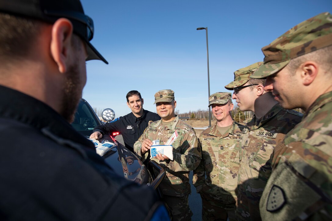 Alaska National Guardsmen Sgt. 1st Class Oliver Meza (center), noncommissioned officer in charge of Drug Demand Reduction, trains guardsmen and police officers in the use of naloxone kits provided through Project HOPE in Wasilla, Alaska, April 13, 2022. The Alaska National Guard collaborates with the Office of Substance Misuse and Addiction Prevention in Project HOPE, a state-run initiative aimed at providing opioid overdose rescue kits and training mission partners and law enforcement agencies. (Alaska National Guard photo by Victoria Granado)