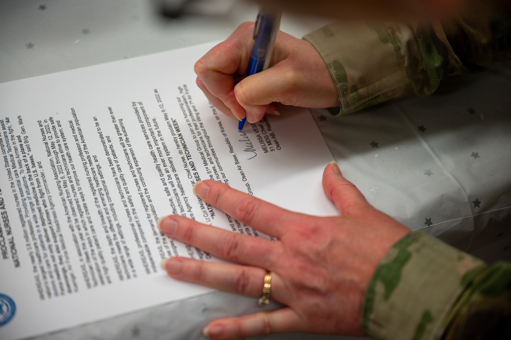 Lt. Col. Melissa Vessar, 51st Medical Group chief nurse, signs the proclamation memorandum in observance of National Nurses and Technician