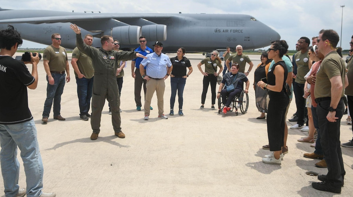 Staff Sgt. Austin Welch, 68th Airlift Squadron loadmaster, speaks with Leadership San Antonio members during a tour of the C-5M Super Galaxy aircraft as part of one of the group’s military-themed days at Joint Base San Antonio-Lackland, Texas, May 4, 2022. LSA was created in 1975 by the San Antonio Chamber of Commerce to help identify and develop community leaders. (U.S. Air Force photo by Airman 1st Class Mark Colmenares)