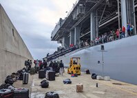 Capt. Michael Concannon, “Gold Crew” commanding officer aboard the Expeditionary Sea Base USS Hershel "Woody" Williams (ESB 4), stands atop the brow welcoming Sailors from the “Blue Crew” while they conduct a crew swap, May 8, 2022.